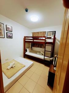 a room with two bunk beds and a door at 727 Anabelle Residence at Marina Spatial Condominium in Dumaguete +5 photos