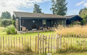 a house with a fence in front of it at 2 Bedroom Cozy Home In Askø in Askø