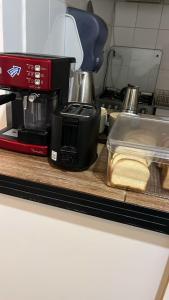 a kitchen counter with a coffee maker and a toaster at Hostal Malú in San Pedro de Atacama