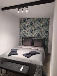 a bedroom with a large bed with a wall with bird wallpaper at Joy's apartment in Markopoulo