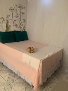 a bed with two seashells sitting on top of it at Quarto Recando do Sol in Aracaju