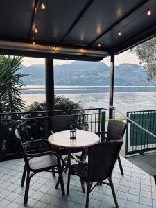a table and chairs on a patio with a view at Camping Baldo in Brenzone sul Garda