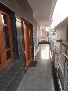 a hallway of a house with wooden doors at Bn Homestay in Mysore +10 photos