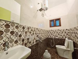 a bathroom with a sink and a toilet at Bn Homestay in Mysore