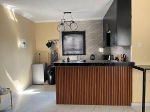 a kitchen with a sink and a counter top at Sedudu Turn Cottages in Maun