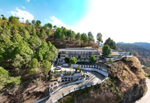 an aerial view of a building on a mountain at Hushvan Resorts in Devaprayāg