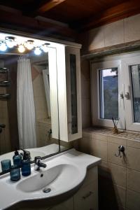 a bathroom with a sink and a mirror at Anéza house tinos in Skaládhos