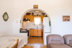a kitchen with an archway and a table in a room at Minas House in Mesochórion