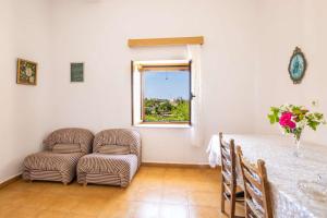 a room with a table and a chair and a window at Minas House in Mesochórion