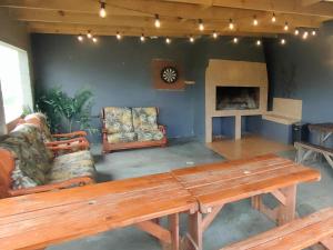 a living room with a wooden table and a couch at Excelsior Country House in Porterville
