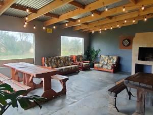 a living room with couches and a table and a fireplace at Excelsior Country House in Porterville