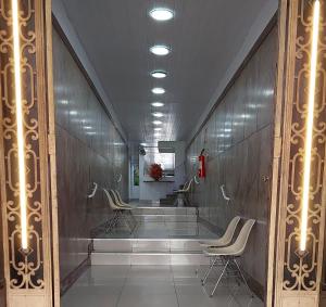 a row of chairs in a waiting room with lights at Hotel Pampulha Palace in Belo Horizonte