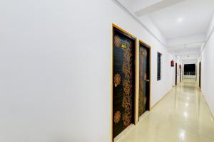 a hallway with paintings on the walls at Super Hotel O Kadam Ghat Near Ashok RajPath in Patna