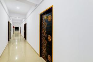 a hallway with a large painting on the wall at Super Hotel O Kadam Ghat Near Ashok RajPath in Patna +39 photos