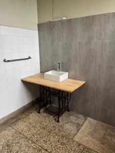 a bathroom with a sink on a wooden table at Woodland villa in Arusha