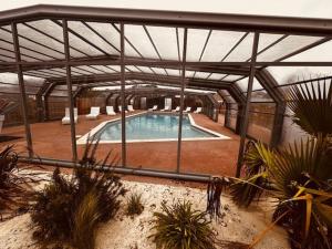 a large swimming pool in a building with anophethritis at Martinette in Saint-Pair-sur-Mer