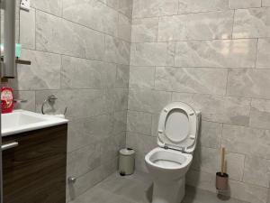 a bathroom with a toilet and a sink at ENA Apartments in Apenkwa