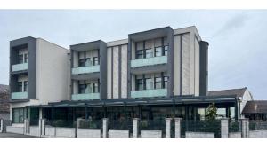 a large white building with a lot of windows at Atri's Boutique in Aiud