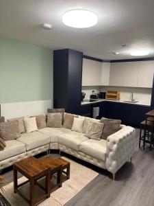 a living room with a couch and a table at Petite Apartment in Denham in Denham