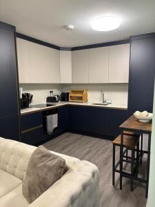 a living room with a couch and a kitchen at Petite Apartment in Denham in Denham +11 photos