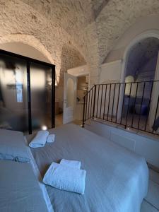 a bedroom with a large bed with two towels on it at Il Balcone di Anna - Luxury Homes in Ceglie Messapica