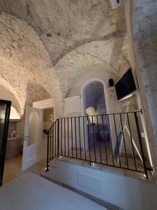 a staircase in a room with a stone wall at Il Balcone di Anna - Luxury Homes in Ceglie Messapica