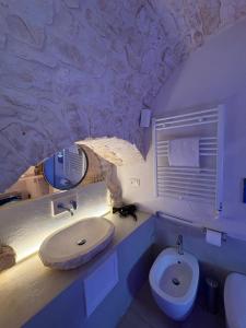a bathroom with a sink and a toilet at Il Balcone di Anna - Luxury Homes in Ceglie Messapica