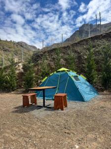 a blue tent with a table and two benches at Camping Koman in Koman