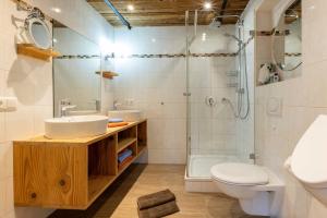 a bathroom with a sink and a shower and a toilet at Streidlhof in Lenggries +68 photos