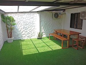 a table and bench in a room with green grass at Sabana Africana in Puerto Triunfo