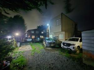 a car parked next to a house at night at cabaña 9 in Punta Arenas