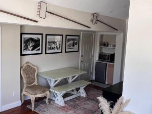 a living room with a table and chairs and a kitchen at Ann Street Inn & Garden in Beaufort