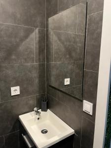 a bathroom with a sink and a mirror at Cozy Room G10 in Valencia