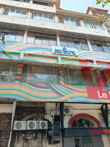 a building with an awning on the side of it at Hotel Regal Gate in Mumbai