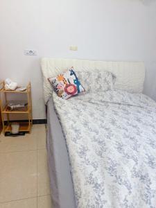 a bedroom with a bed with a blue comforter and pillows at Private room on the 6th floor in Beijing +6 photos