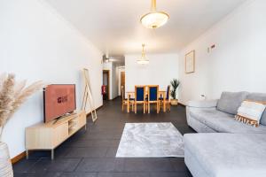 a living room with a couch and a table at GuestReady - Charming Apartment with Ocean Views in Caniço