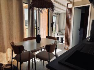 a dining room with a table and chairs and a room at Martinette in Saint-Pair-sur-Mer +4 photos