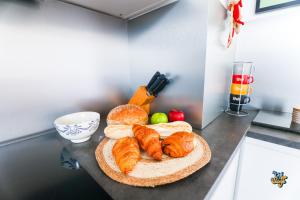 a tray of croissants and other breads on a counter at La Loge de la Tour in Calais