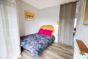 a bedroom with a bed with red pillows on it at La Loge de la Tour in Calais +13 photos