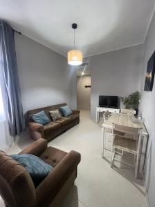 a living room with a couch and a table at Almendra B Vitalba Apartments in Lanjarón