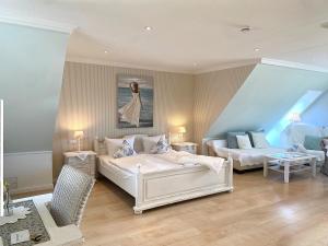 a living room with two beds and a couch at Haus Anholt in Timmendorfer Strand +107 photos