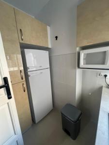 a small kitchen with a white refrigerator and a microwave at Almendra B Vitalba Apartments in Lanjarón