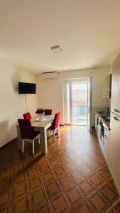 a kitchen and dining room with a table and chairs at sole in Novara
