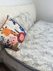 a bed with two pillows on top of it at Private room on the 6th floor in Beijing