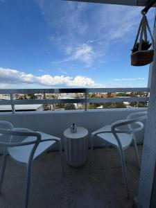 a balcony with chairs and a table and a view of the ocean at City Vibes - Central 3BR Spacious Apartment in Larnaca +27 photos