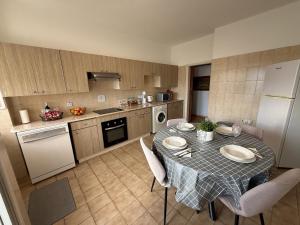 a kitchen with a table and chairs in a kitchen at City Vibes - Central 3BR Spacious Apartment in Larnaca