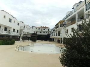 a courtyard with a pool in the middle of buildings at corali in Tersephanou