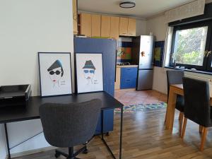 a kitchen with a table with pictures on it at Apartman Novak in Samobor +10 photos