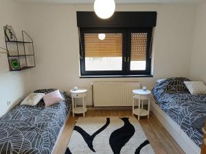 a bedroom with two beds and a window at Apartman Novak in Samobor