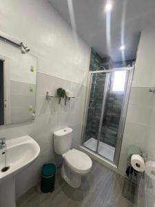 a bathroom with a toilet and a sink and a shower at Almendra B Vitalba Apartments in Lanjarón +6 photos